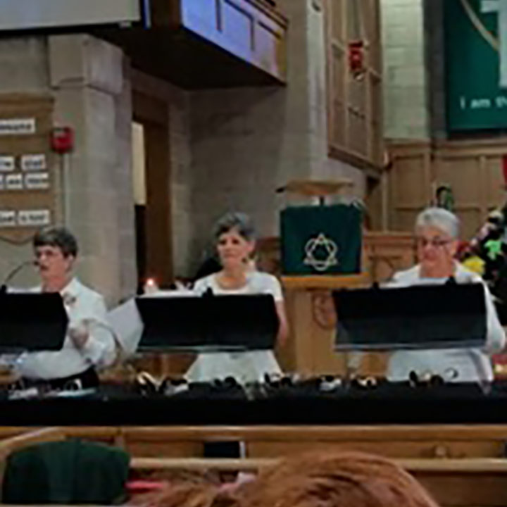 bell choir playing a song near the front of church