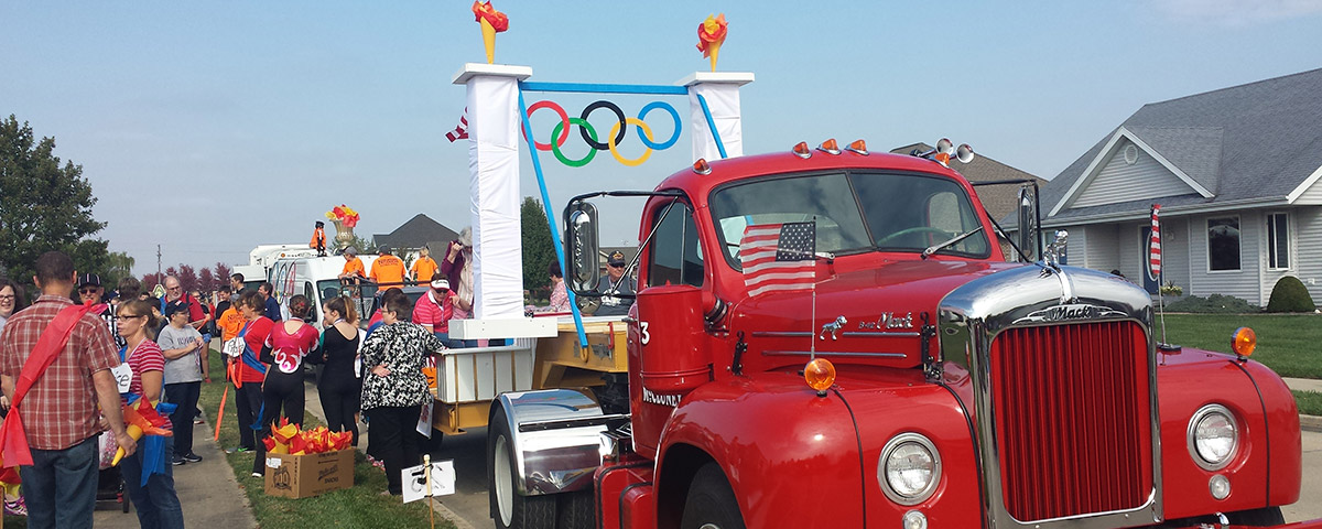 Centenary members standing next to Halloween parade float and vintage Effingham Fire Department fire engine