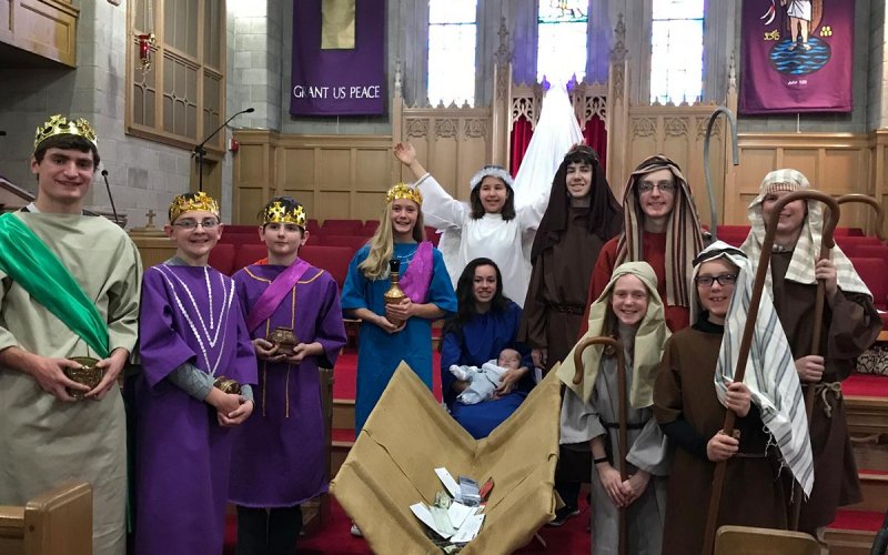 Centenary youth posing as the nativity scene characters in front of church