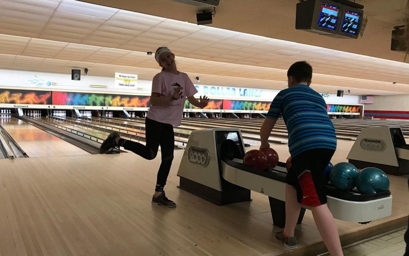 Centenary children having fun at a bowling alley