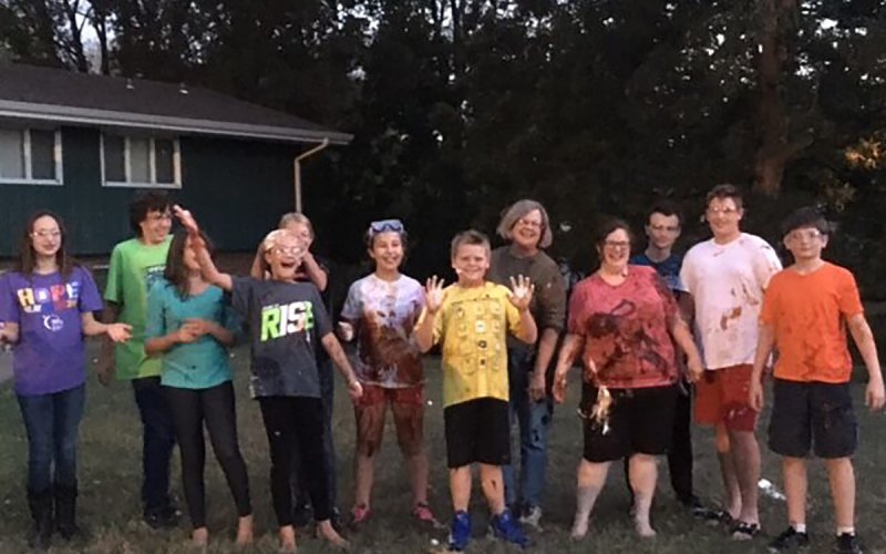 Centenary youth and staff smiling for the camera after a food fight