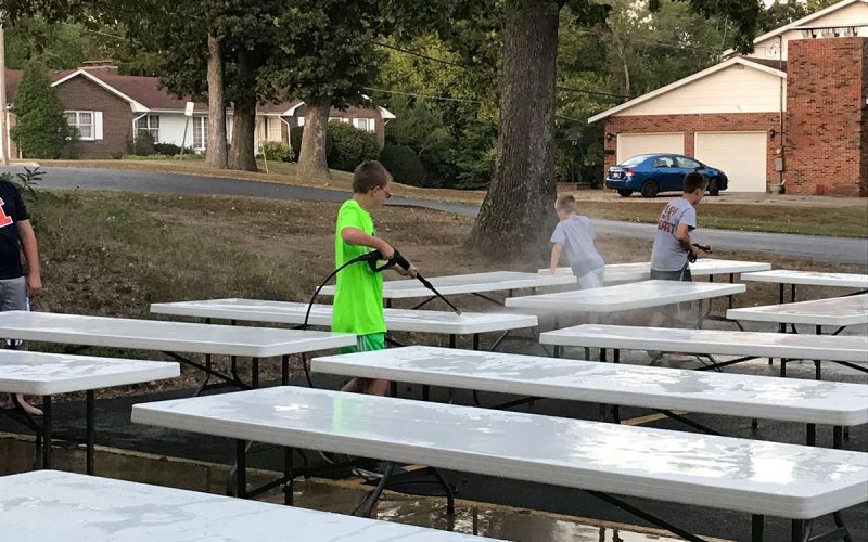 youth washing off tables