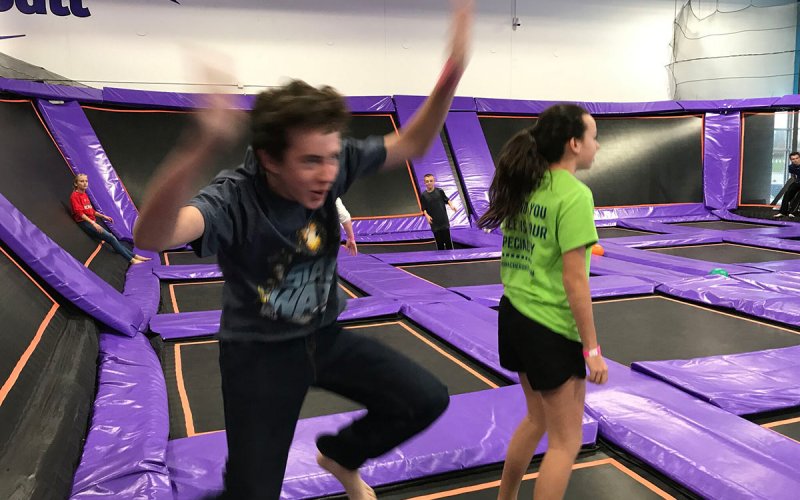 Centenary youth having fun on trampolines