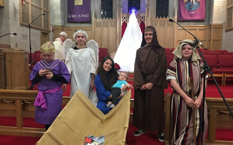 Centenary youth dressed dressed up as the nativity scene in front of church