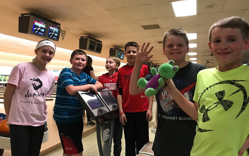 Centenary youth having fun at a bowling alley